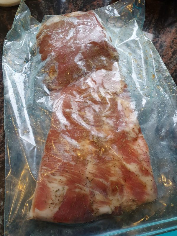 Stop de buikspek in een ziplock zak. Een vacuumzak kan ook, maar trek niet te veel vacuum: je wil ruimte overhouden voor het vocht
Leg de zak in de koelkast
